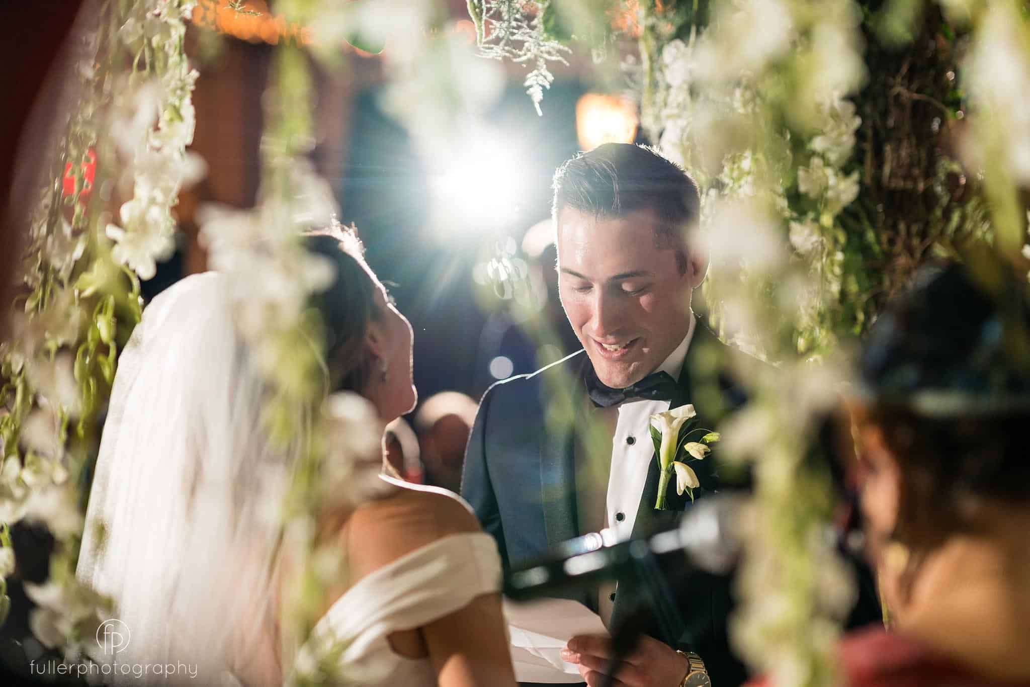 Groom reading his vows to the bride at their indoor Penn Oaks ceremony