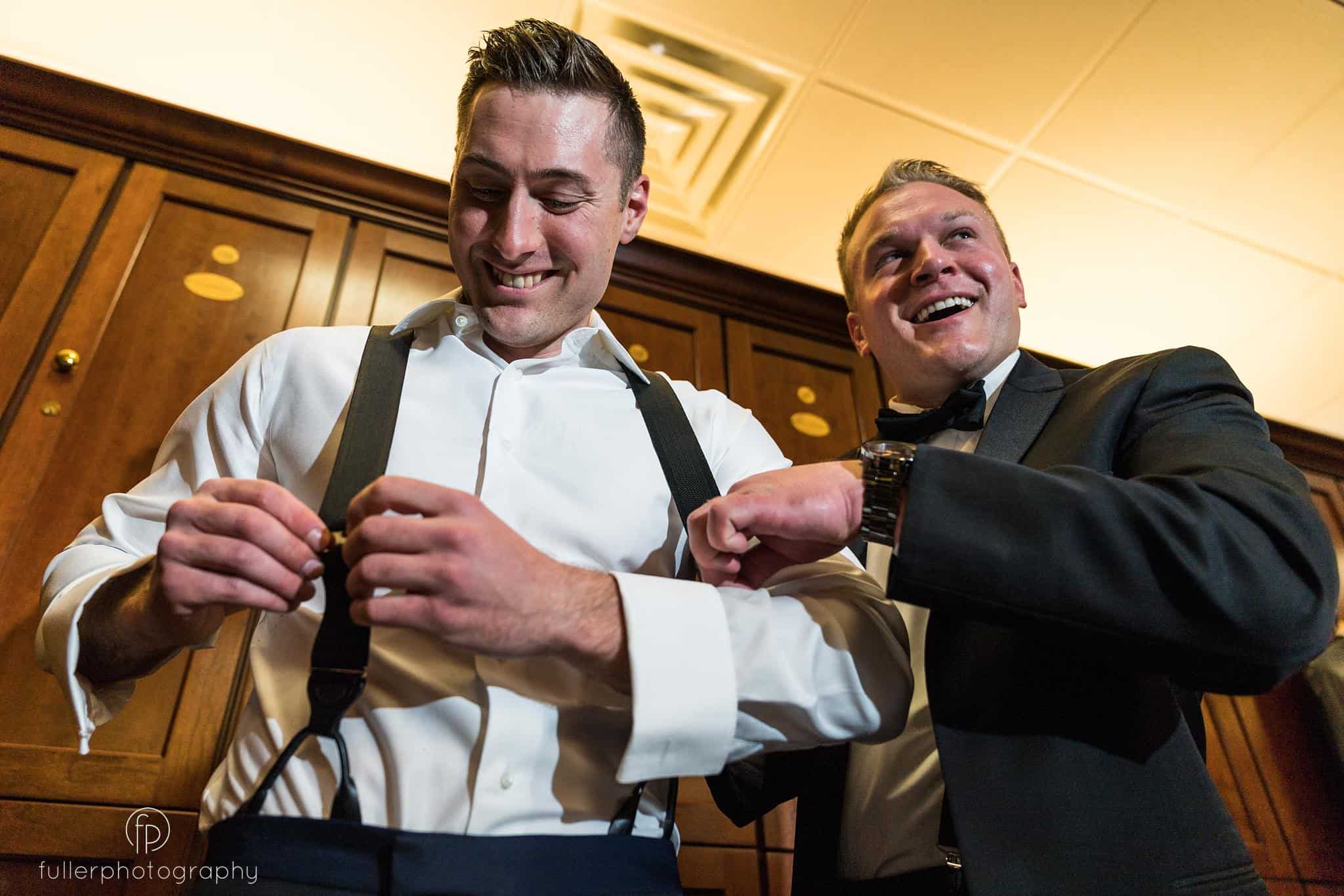 Groomsmen teasing the groom while he's getting ready