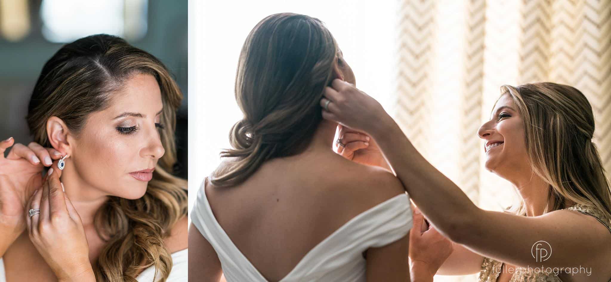 Maid of honor helping the bride get her earrings in while smiling