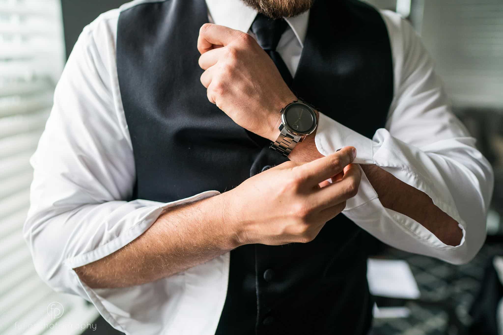 Groom buttoning his shirt before his Deerfield Country Club Wedding