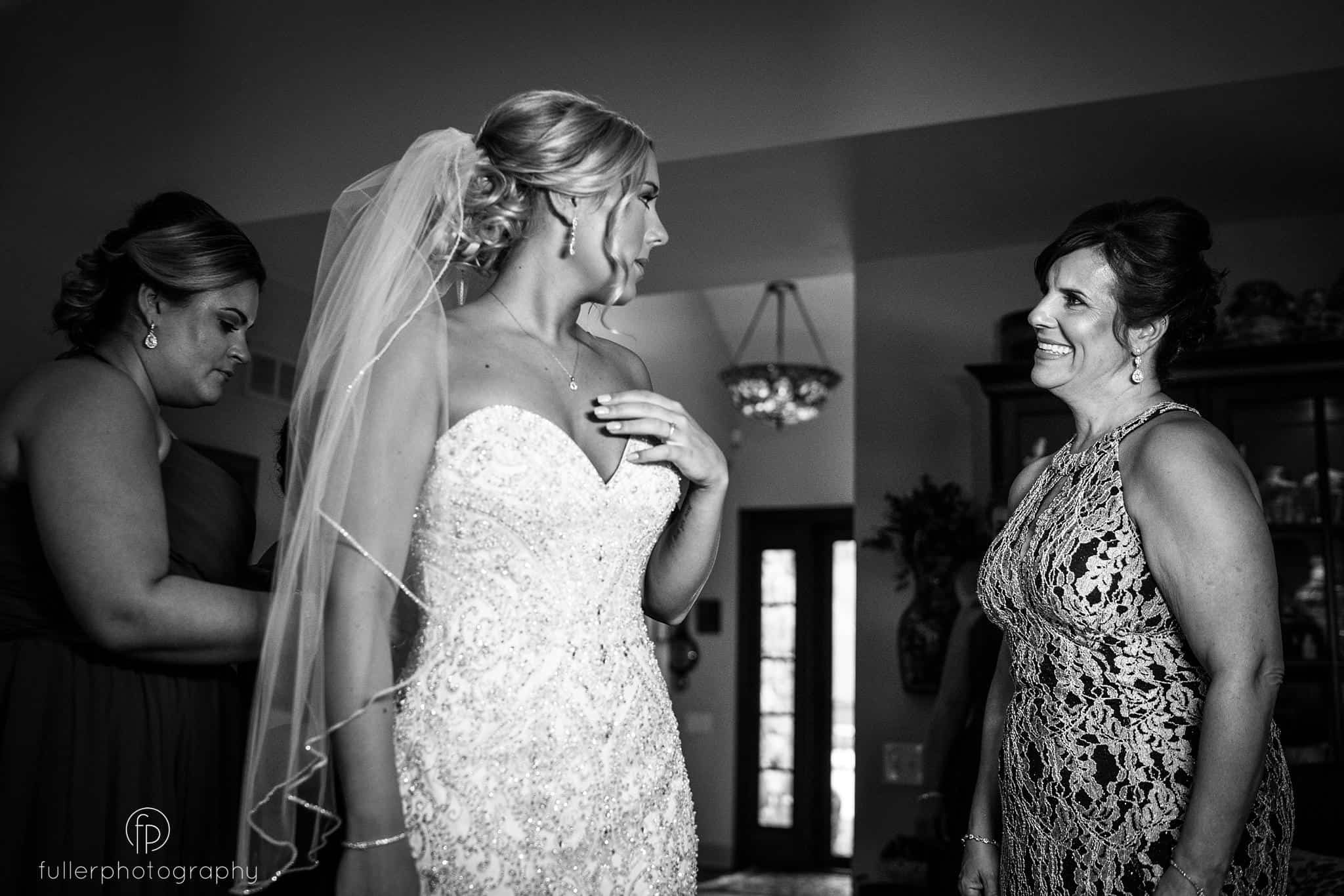 The brides mother smiling at her beautiful daughter before their Deerfield County Club wedding