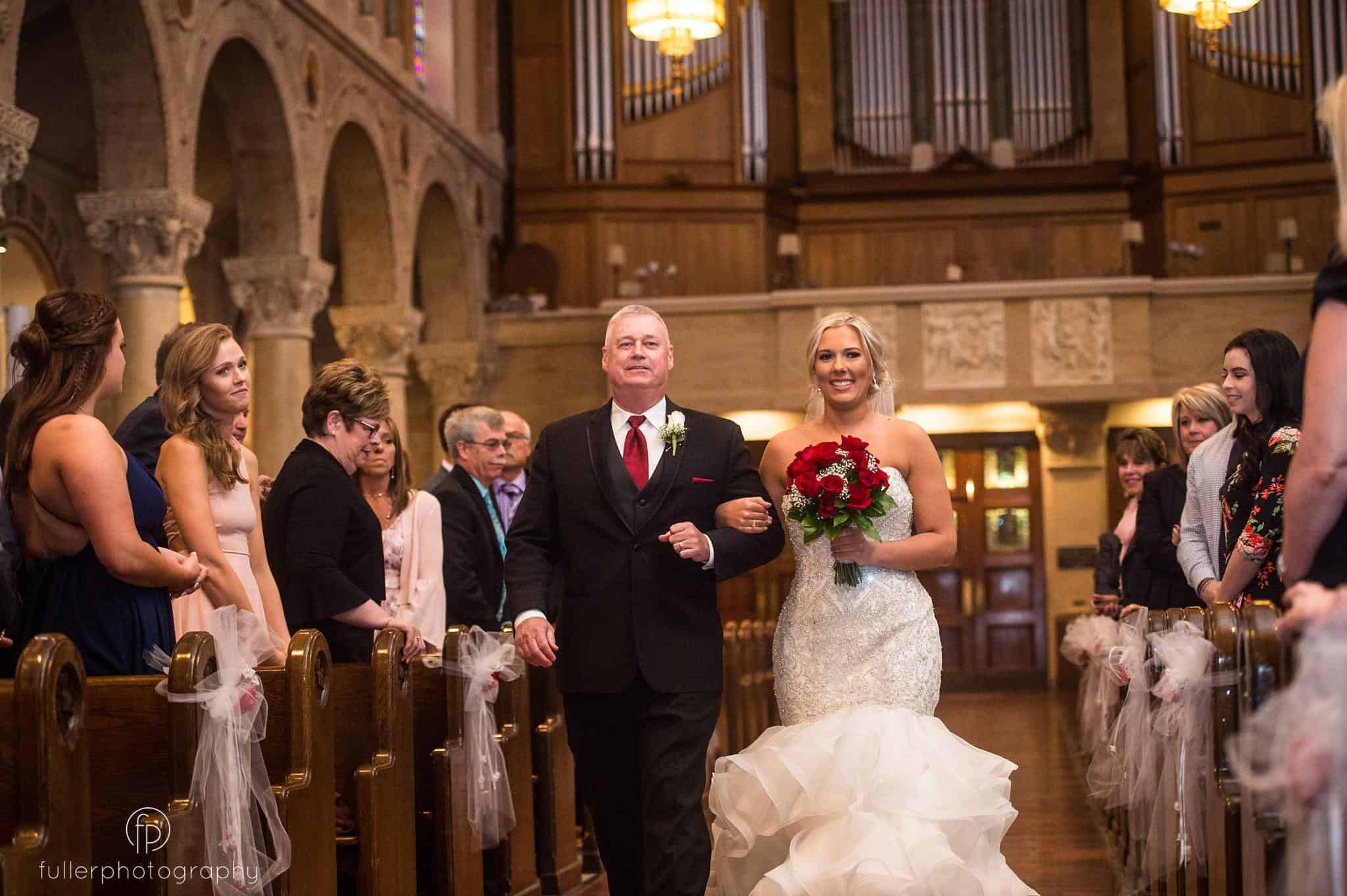 The bride's father waking her down the isle at St Anthony's church