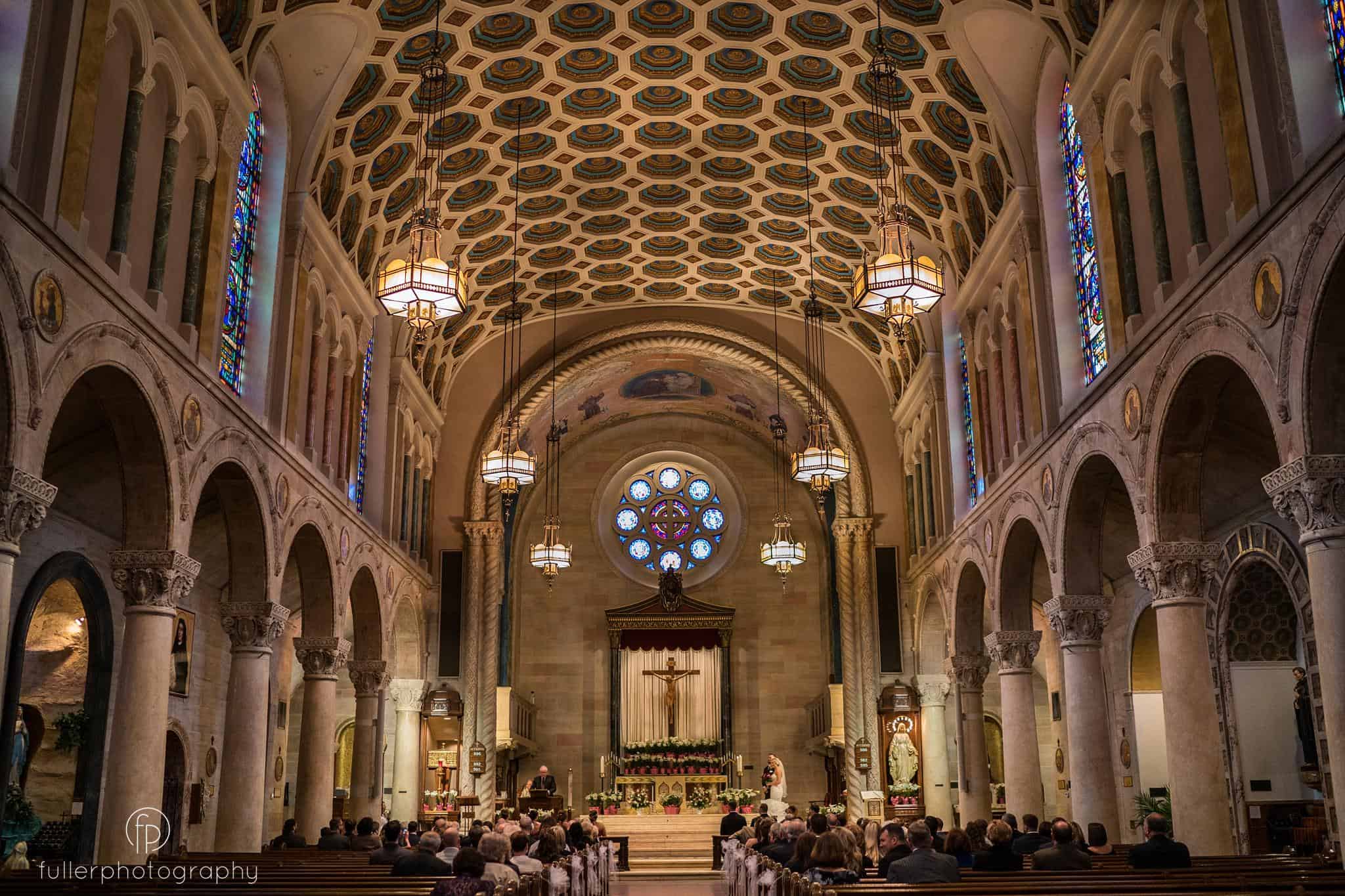 wide angle portrait of the church ceremony at St Anthonys in Wilmington Delaware
