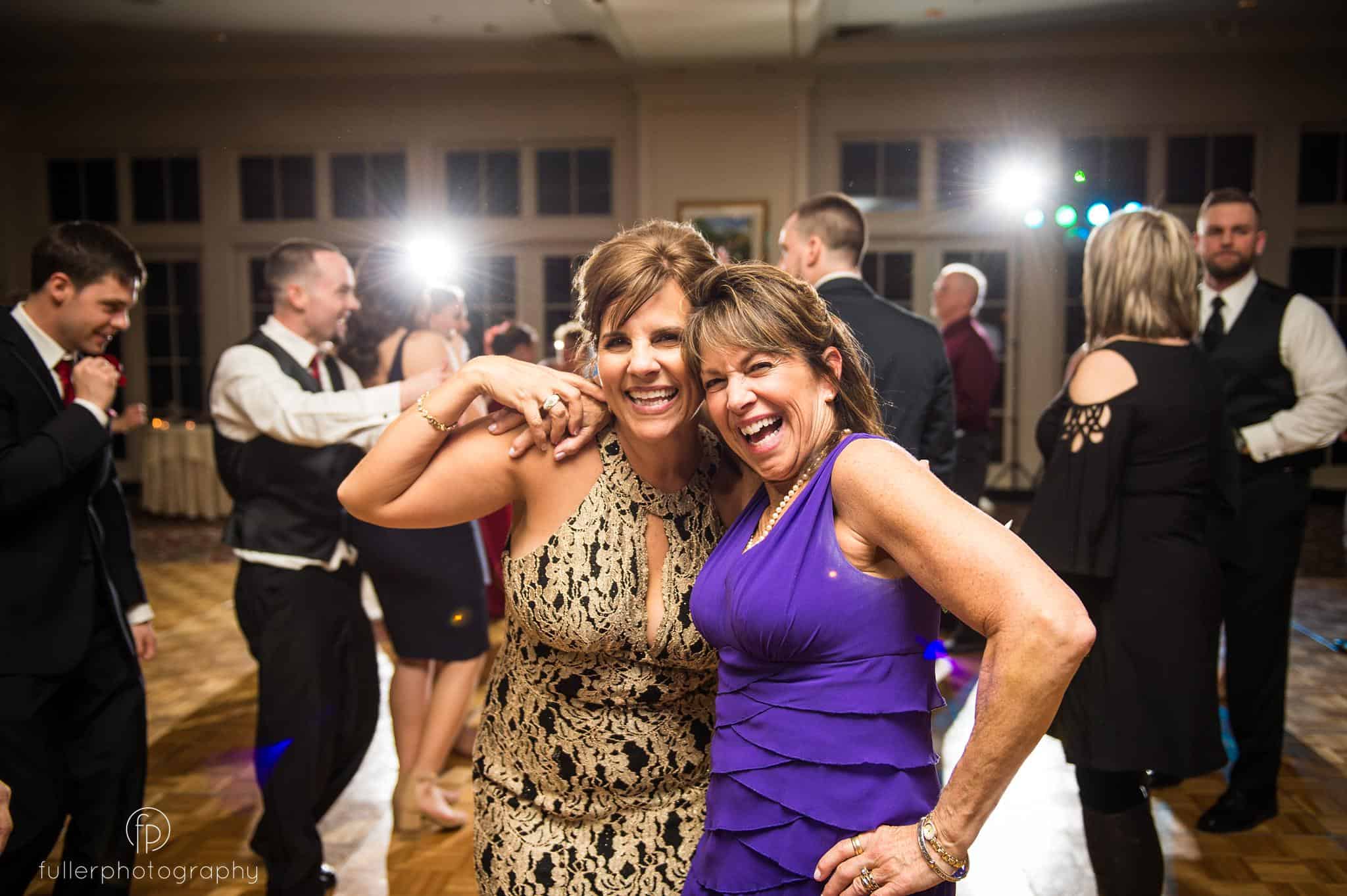 Brides mother and relative dancing and laughing during their wedding reception