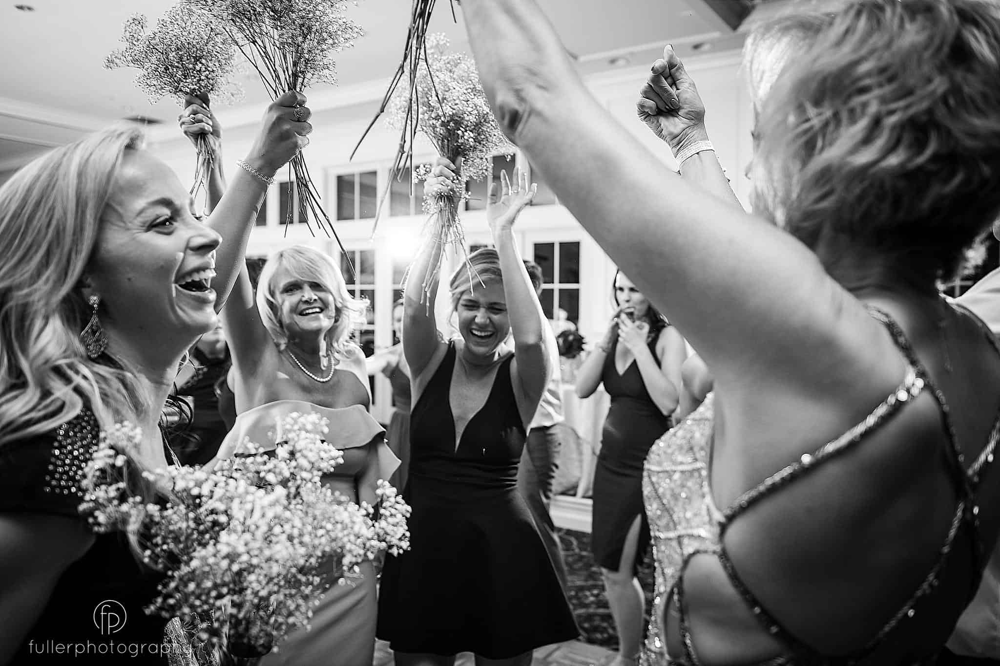 Bride and groom's relatives having a great time time on the dance floor during the wedding reception at Deerfield Golf Club