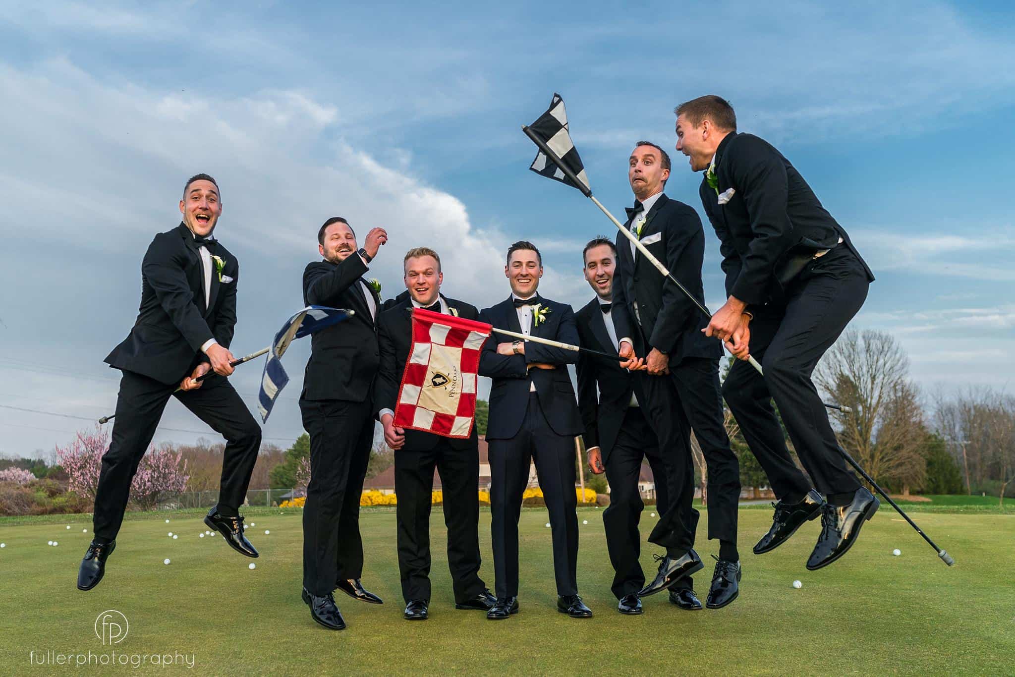 Groomsmen playing with the golf flags