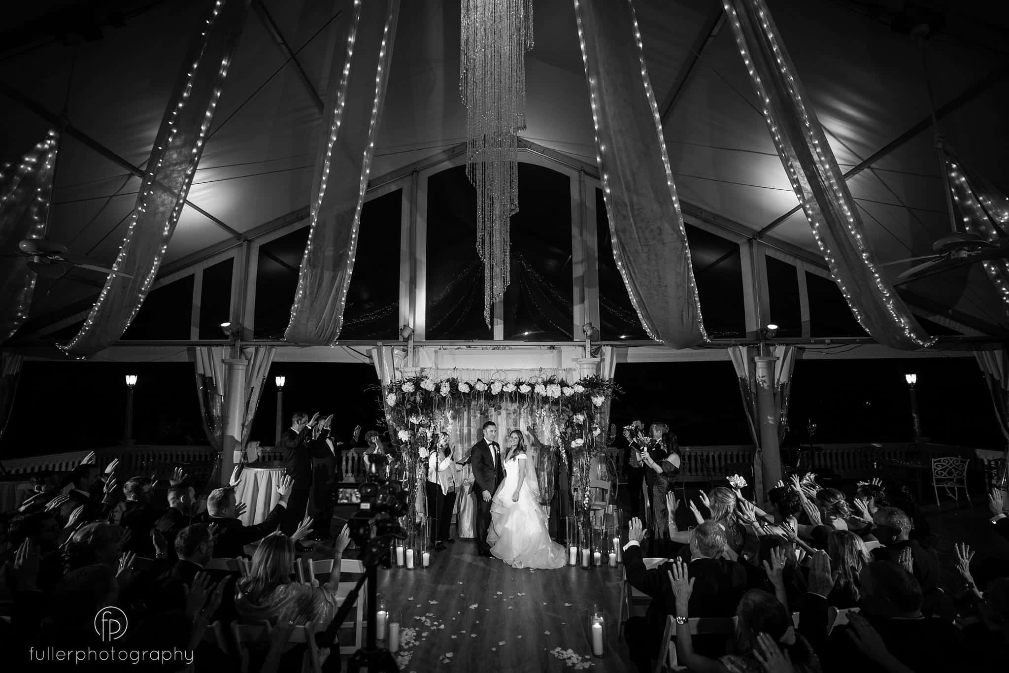 Guests praying for the couple during their indoor wedding ceremony at Penn Oaks