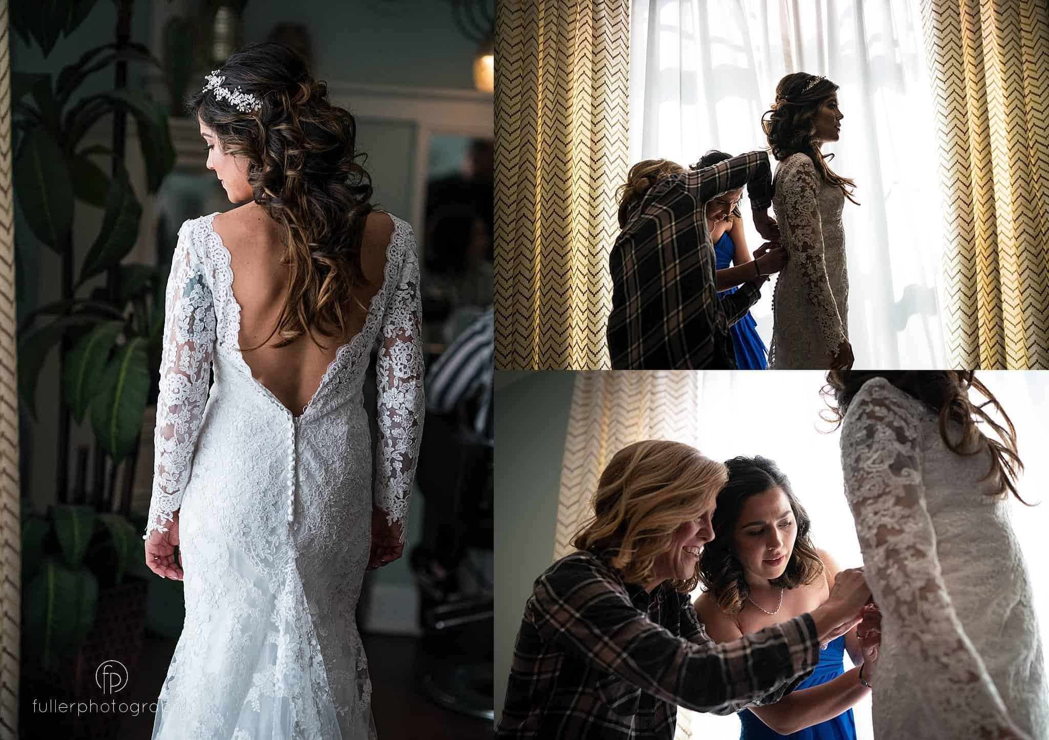 Bride putting on her dress with the help of sister and mother at Penn Oaks