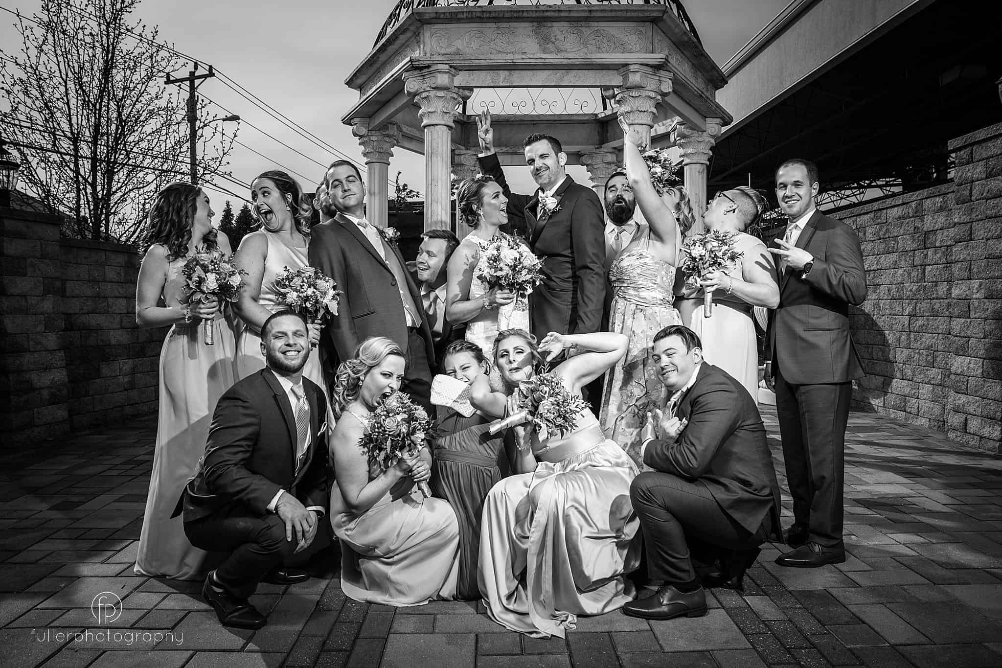 Wedding party cheering during a portrait at Lucien's Manor