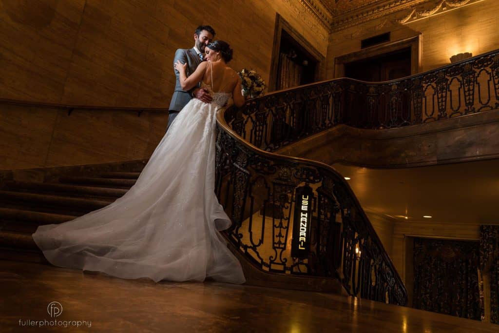 bride and groom on the stairs hugging in a romantic pose on the Hotel Dupont Wedding