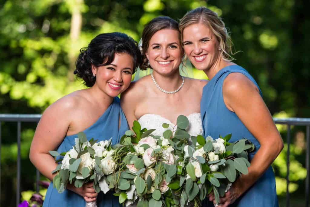 Bride and bridesmaids posing on the Knox Estate patio