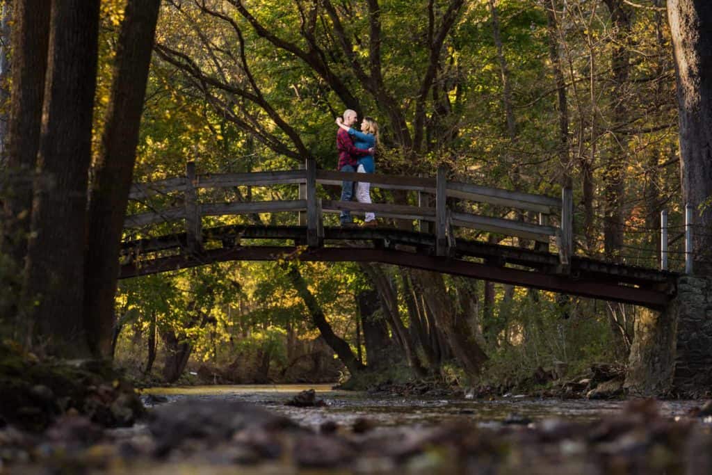 Couple posing on the foot bridge at Knox Estate