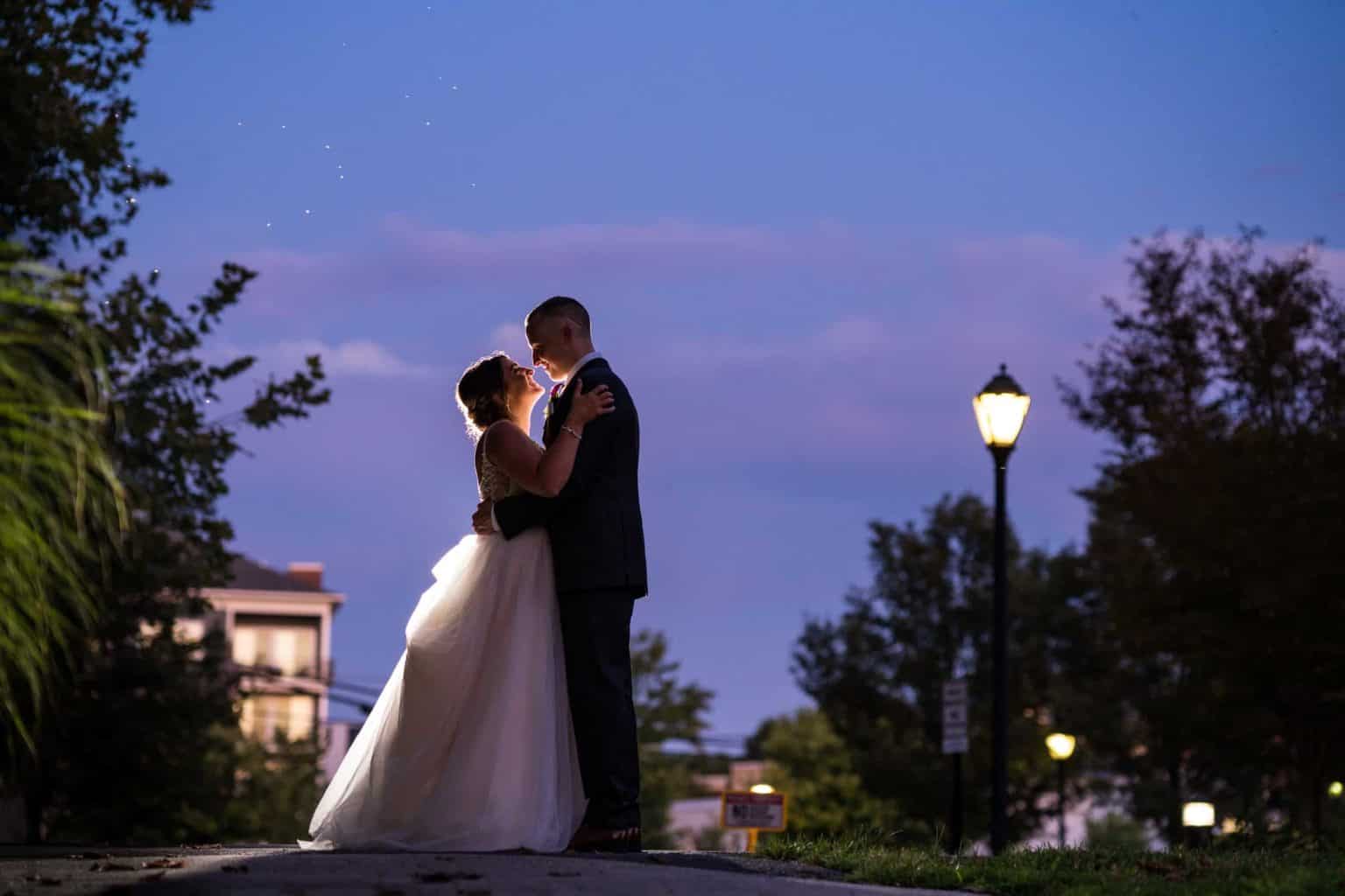 Bride and groom outside of Phoenixville Foundry during sunset