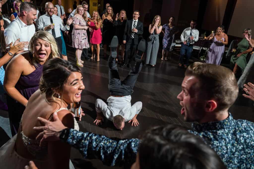 Groom dancing as the bride laughs on the Phoenixville Foundry dance floor