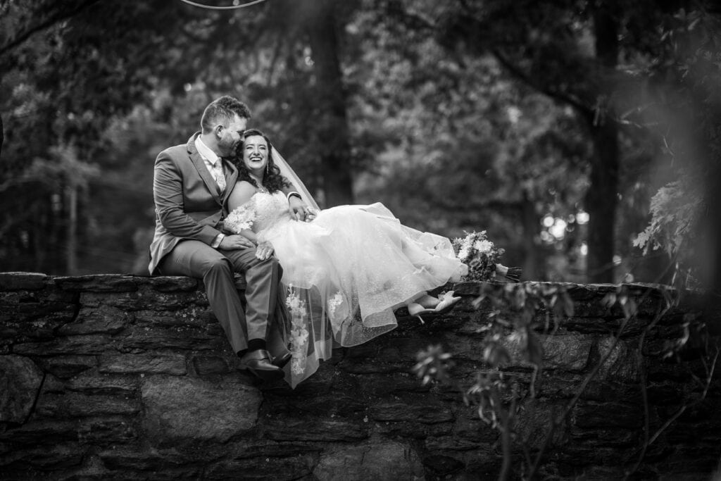 Couple sitting on the wall together at their Huntingdon Valley Country Club Wedding